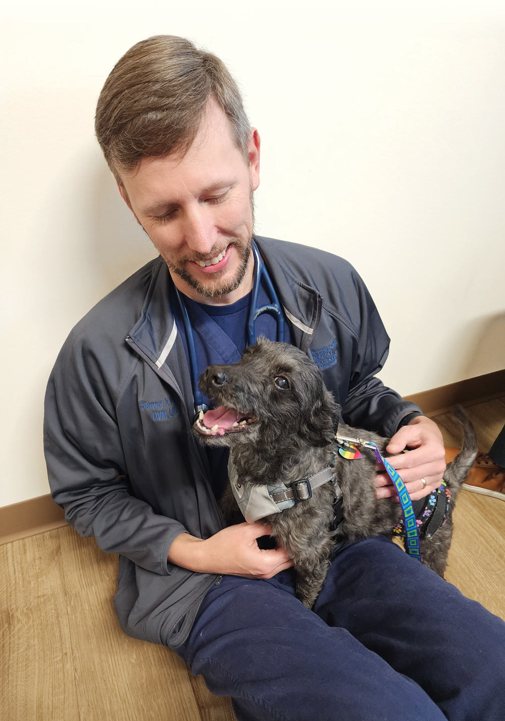 Dr. Steven Honzelka with a dog in his lap