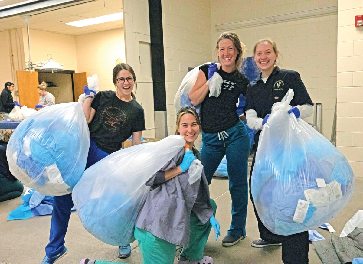 Veterinary students holding bags of medical waste at Colorado's states vet school