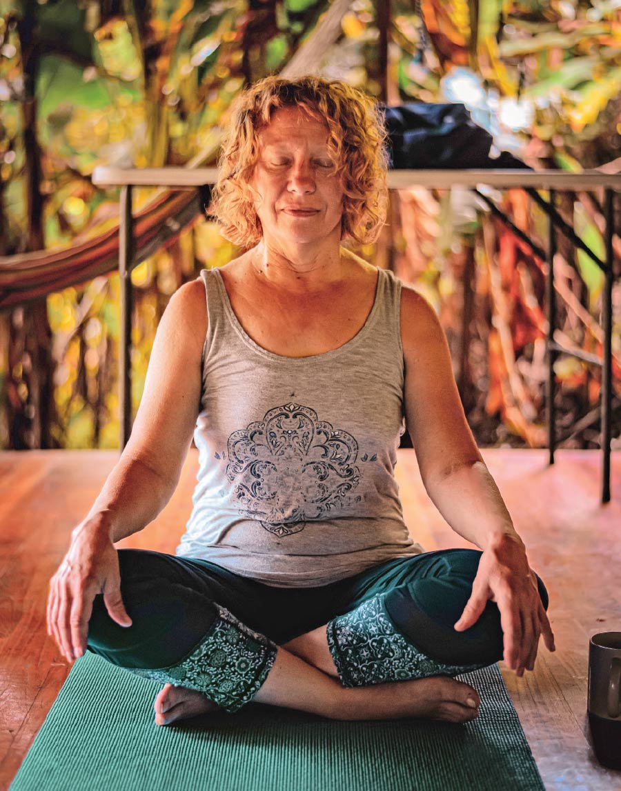 woman meditating while doing yoga