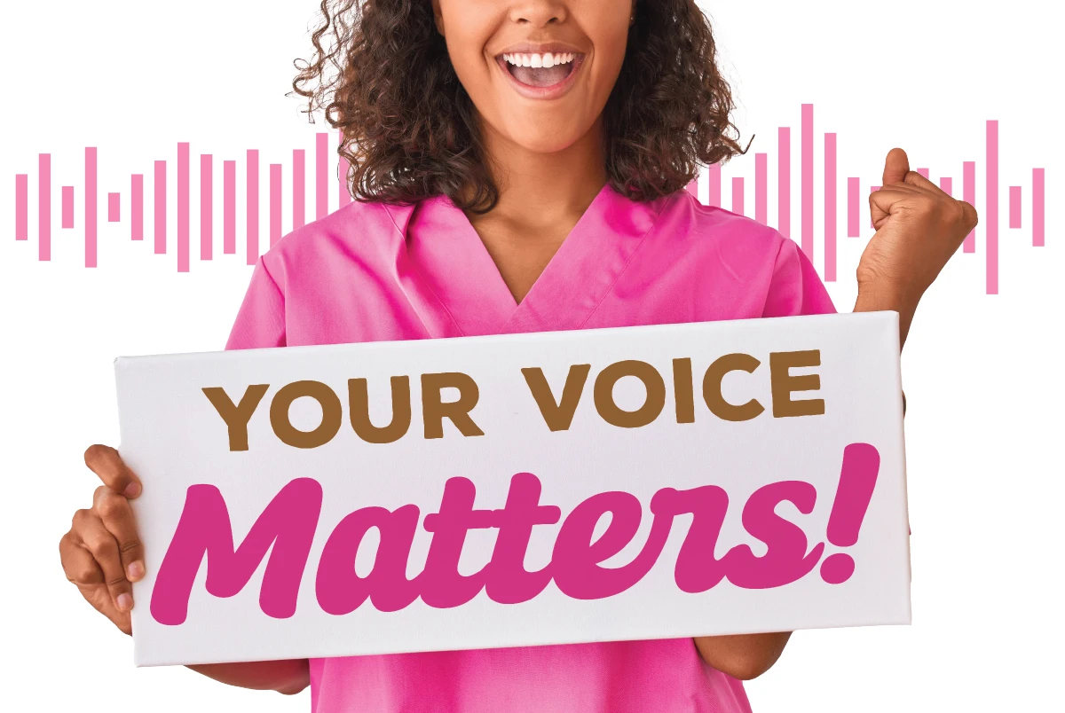 veterinary technician wearing pink scrubs and holding a sign saying "Your Voice Matters!"